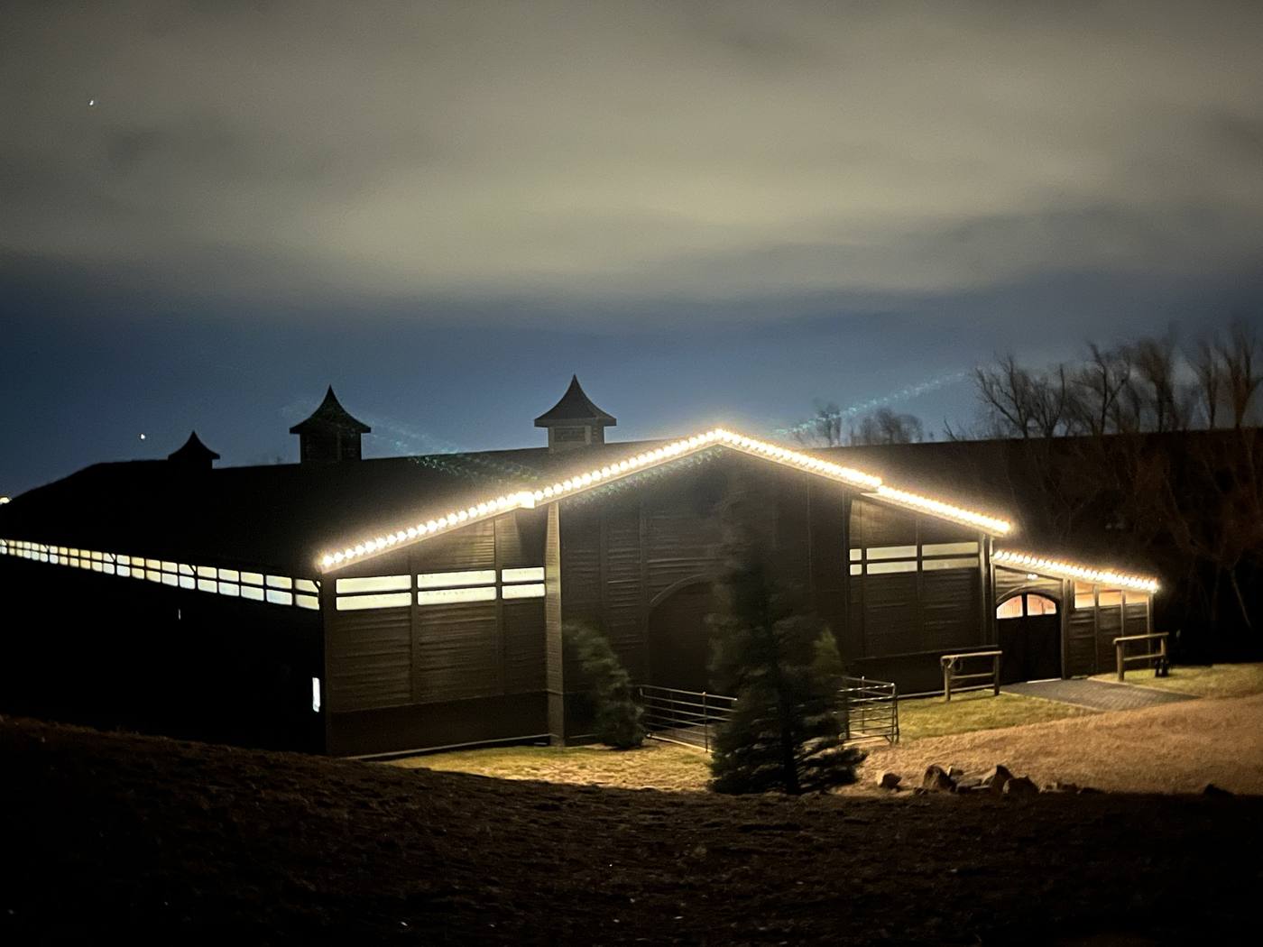 Christmas light installation on a barn roofline, Boulder County, CO