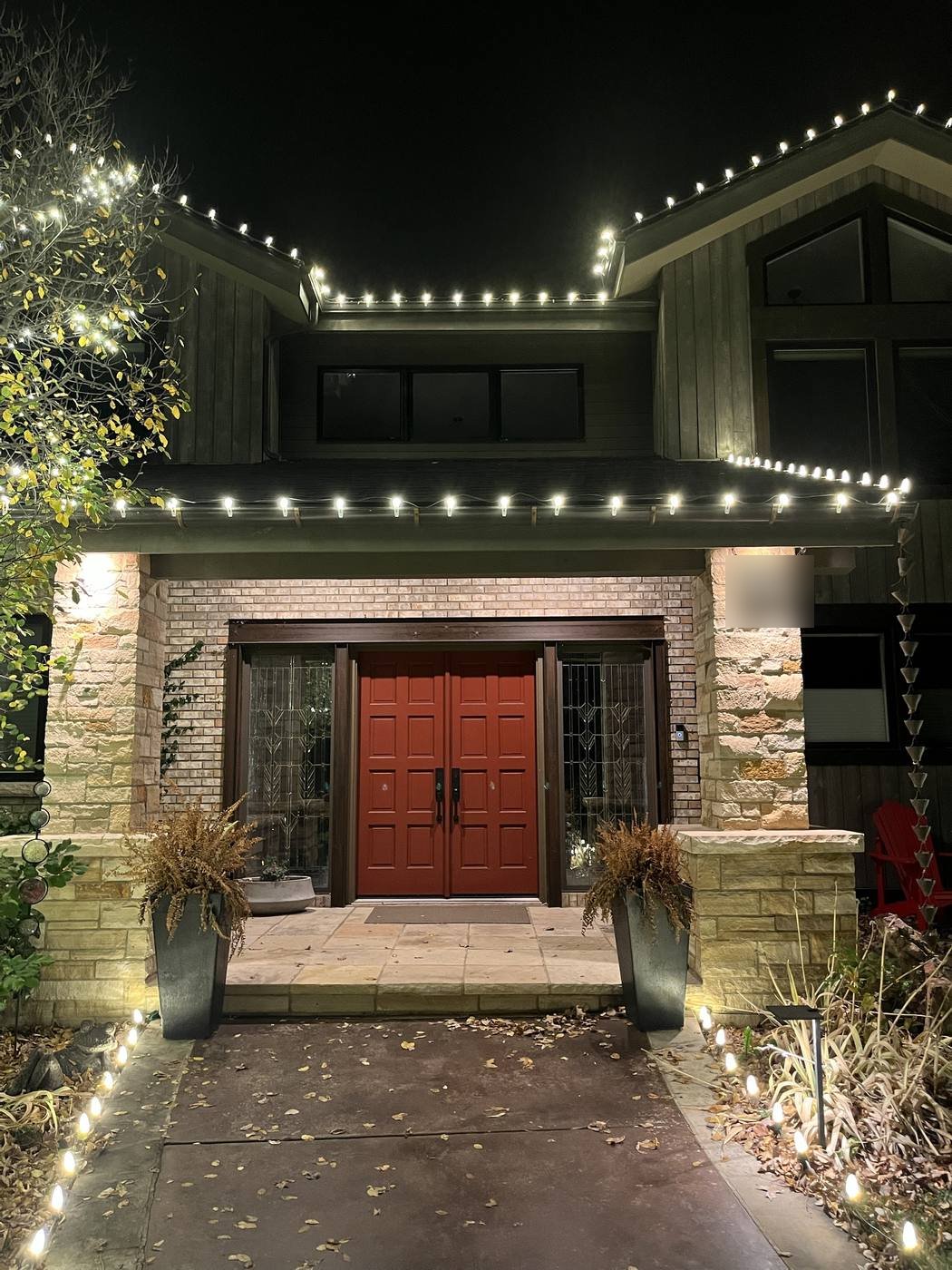 Roofline lights over a front entry with a red door