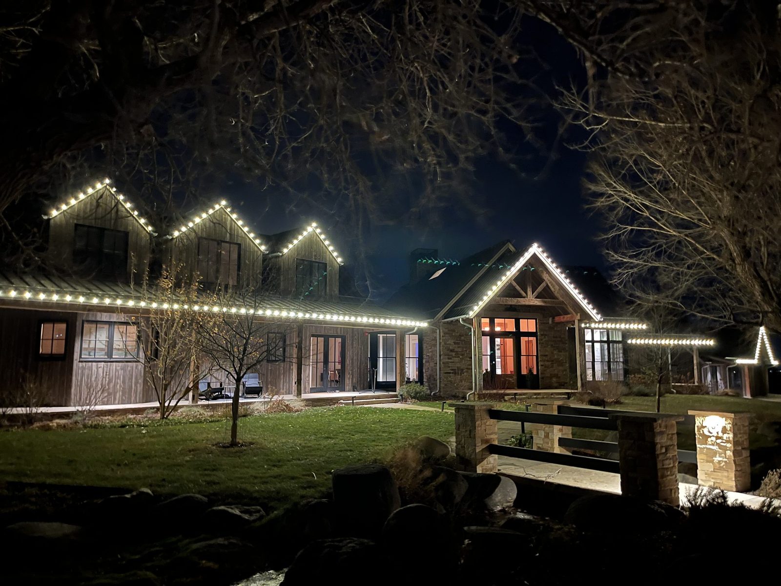 Christmas lights on the gables and rooflines of a farmhouse near Boulder, CO