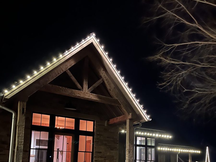 Christmas lights along a gable roofline and eaves